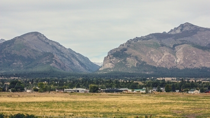 Two sturdy mountain peaks come together, at their base lies one of the many scenic and safe communities that permeate the Ravalli County in Montana. 